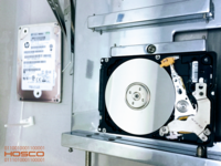 Screenshot of Hosco Data Recovery provides advanced physical media repair within a controlled laboratory environment tailored for delicate procedures like read/write head assembly replacement. The pictured hard drive originates from an HPE storage system and has undergone expert technical intervention aimed at restoring its minimal operational integrity. All repair processes are conducted under direct supervision by experienced technical leadership to ensure strict quality standards and data security.