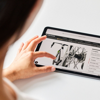 Screenshot of a person using a 3D bike configurator on a tablet device.